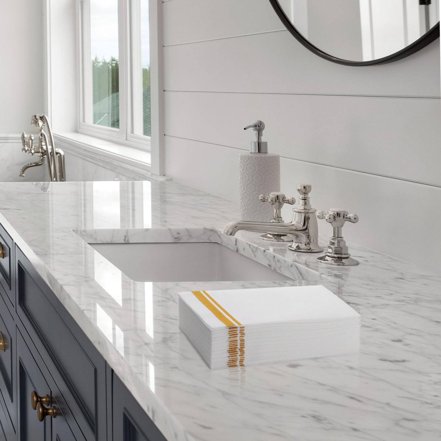BloominGoods guest towel with gold double-line border folded on bathroom counter