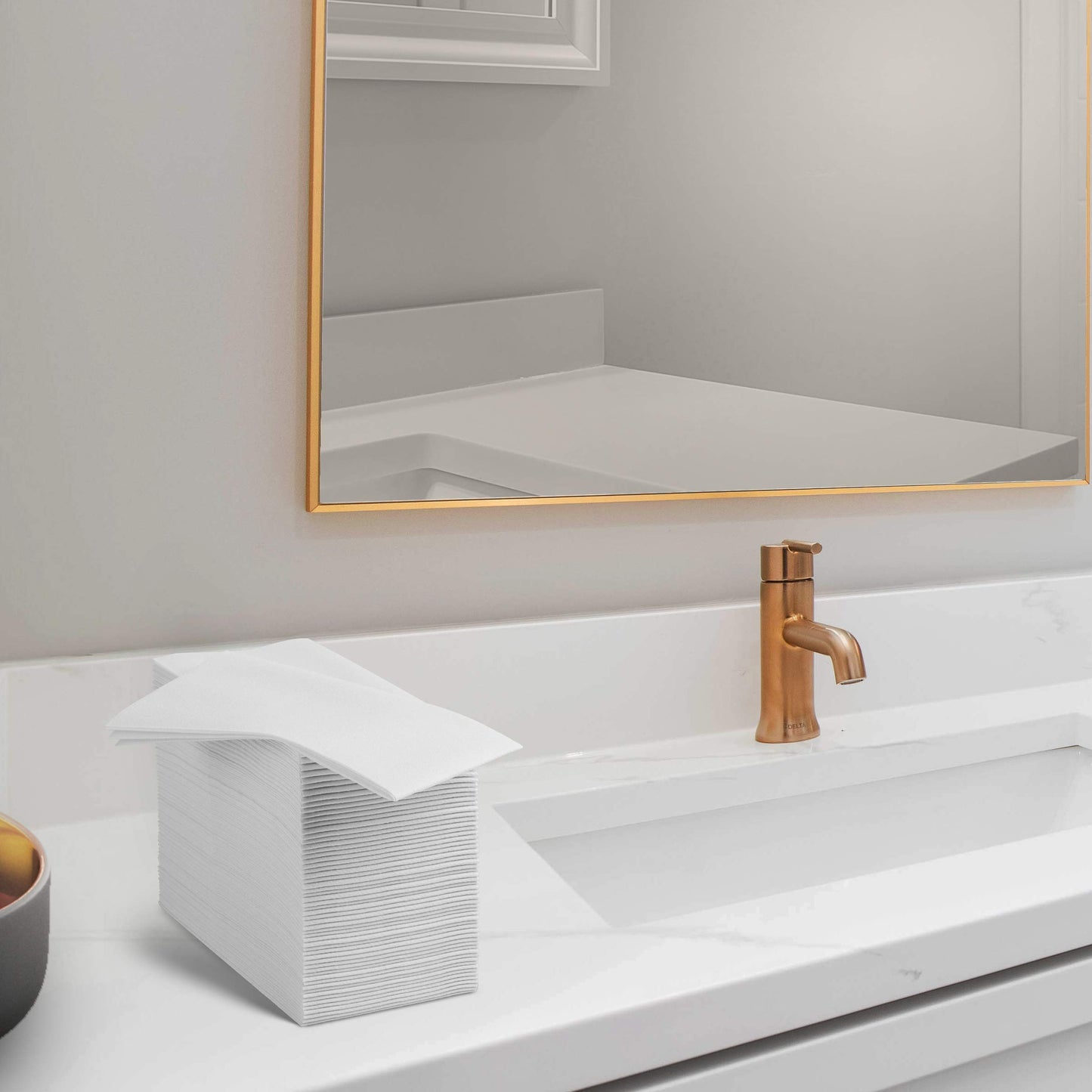 Linen-like airlaid guest towel by Servietto folded on bathroom counter