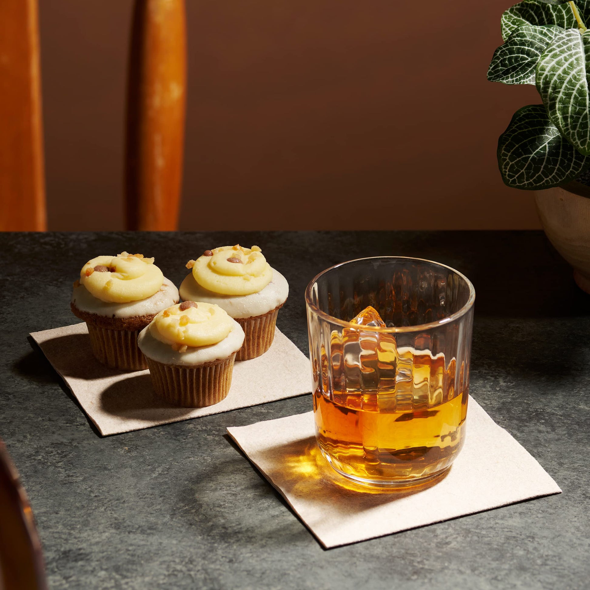 Elegant whiskey glass resting on natural color disposable napkin Naperee