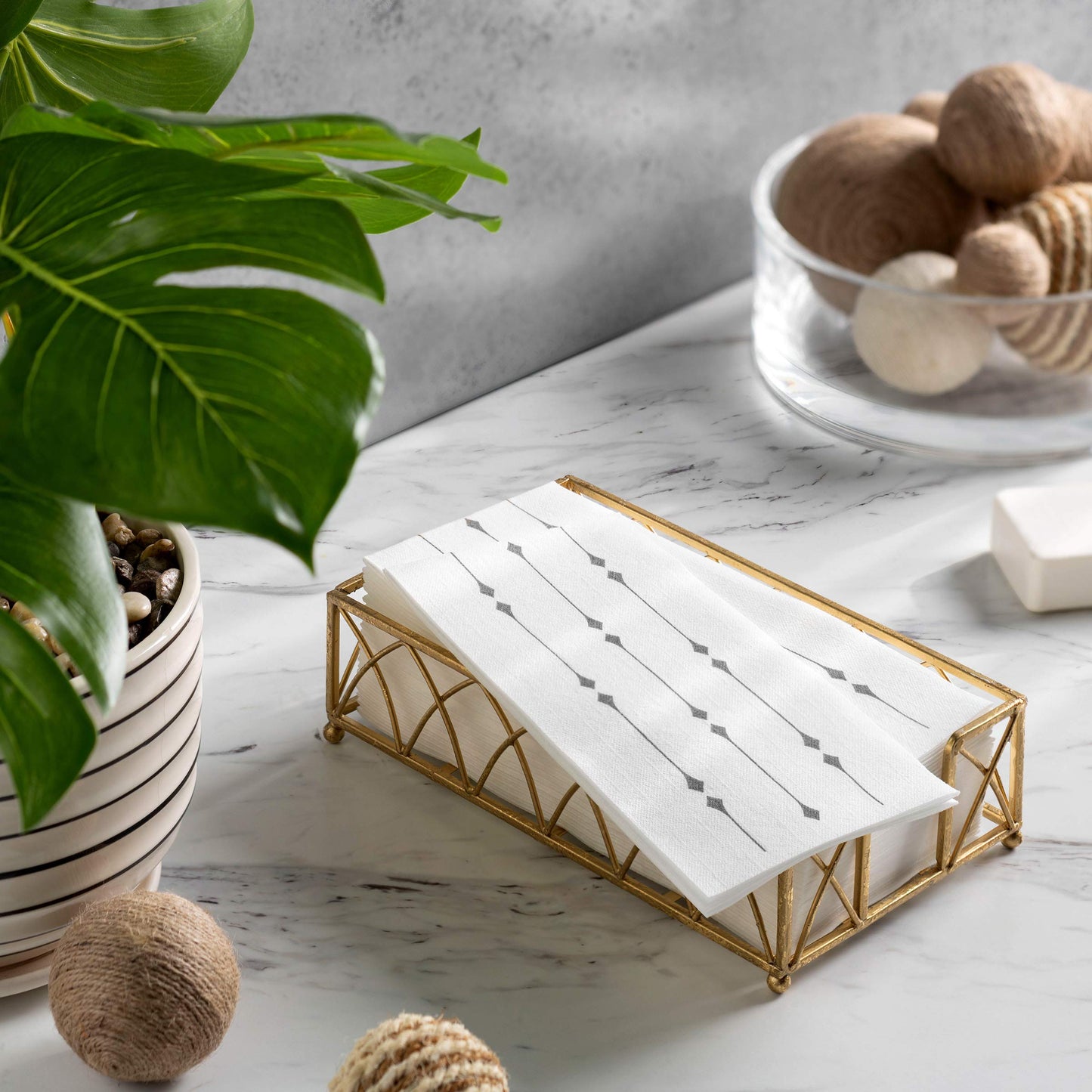 Airlaid silver diamond guest towel displayed in napkin tray on a table
