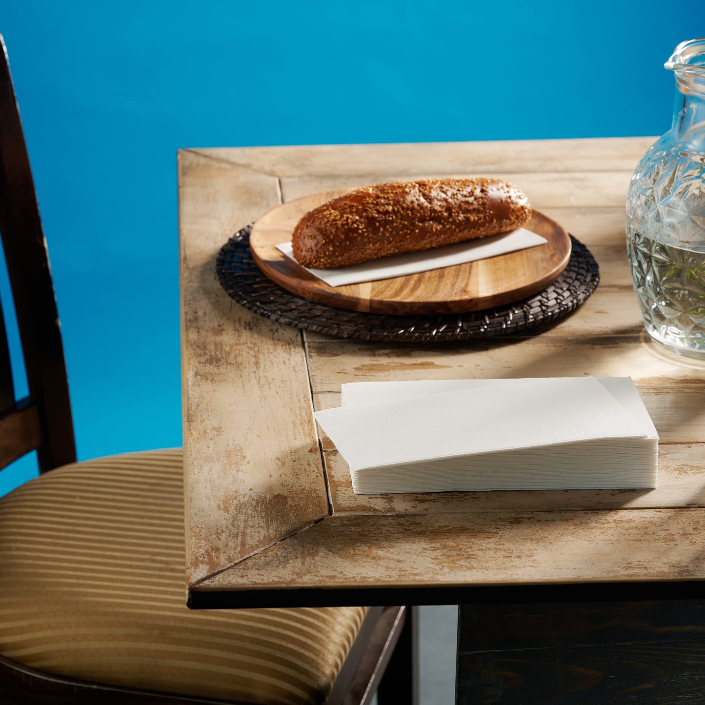 NP-PPGT-WHT-75, Cloth-like napkin holding fresh bread on wooden dining table