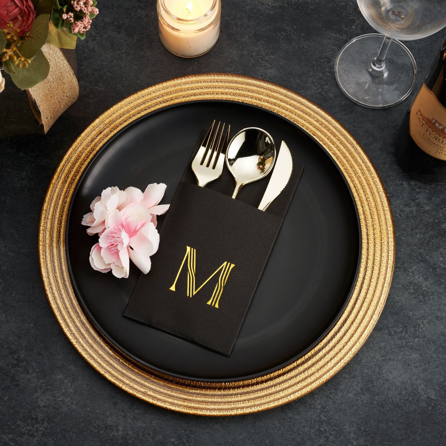 M monogram in gold foil on black airlaid dinner napkin with pocket