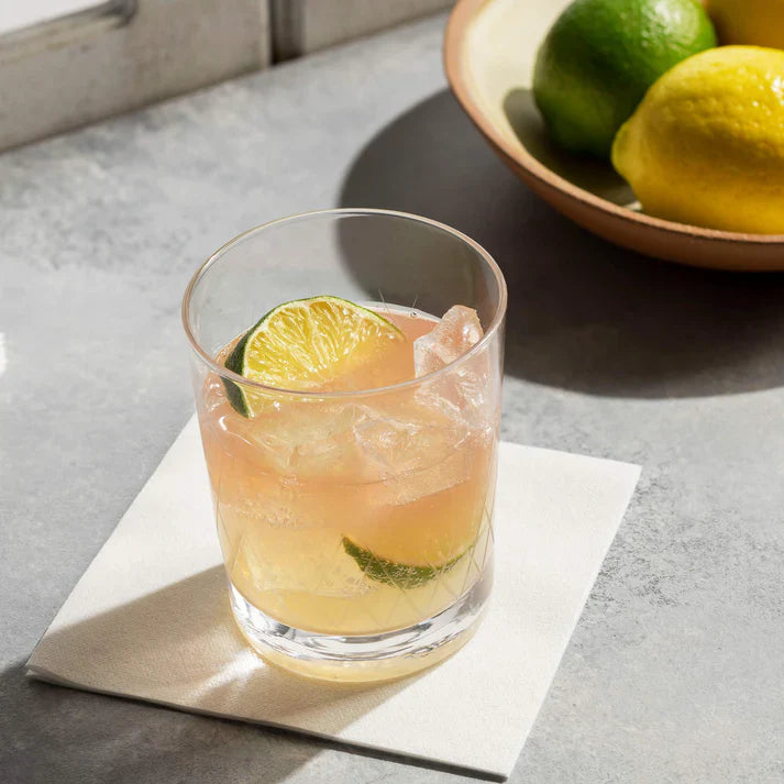 Bar napkins with orange drink on it